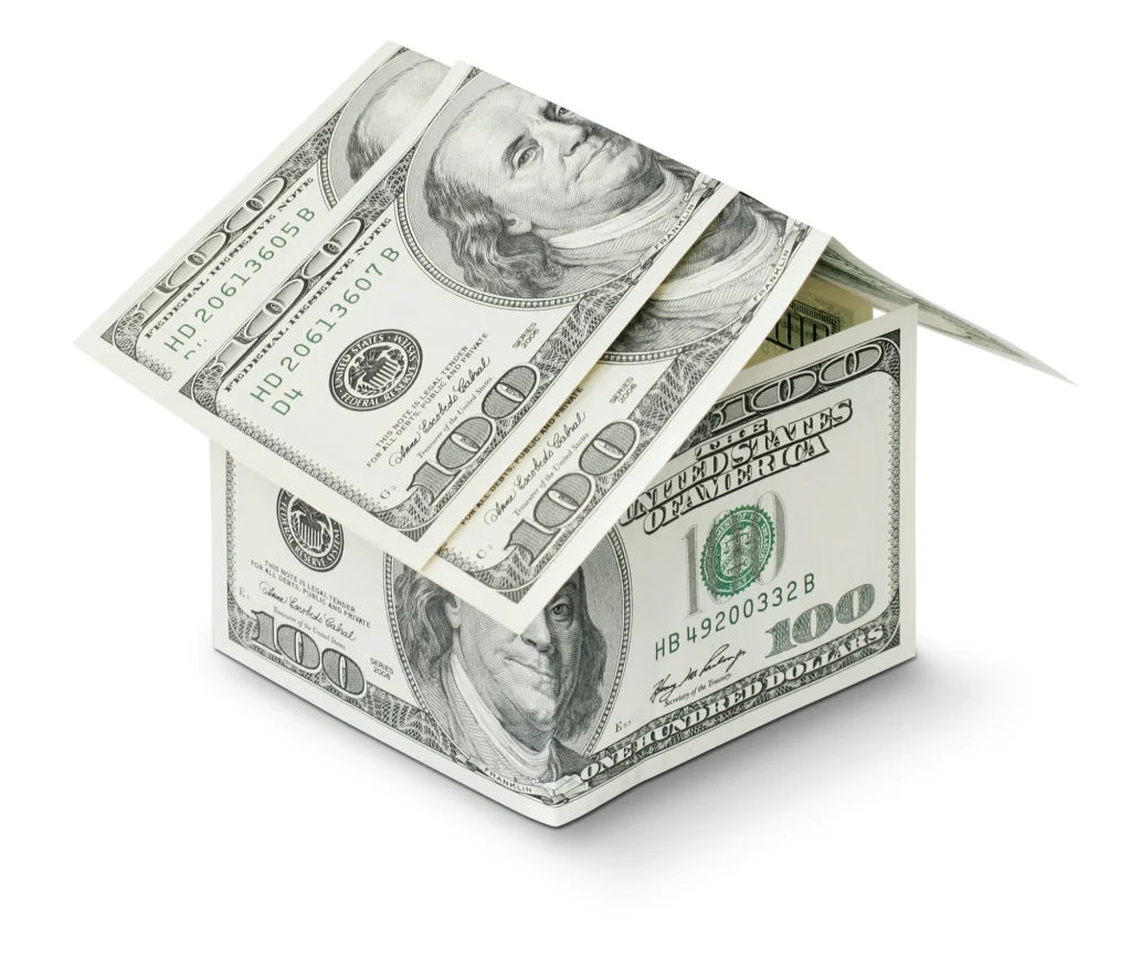 A house made of US hundred-dollar bills, symbolizing the financial aspects of the real estate market.